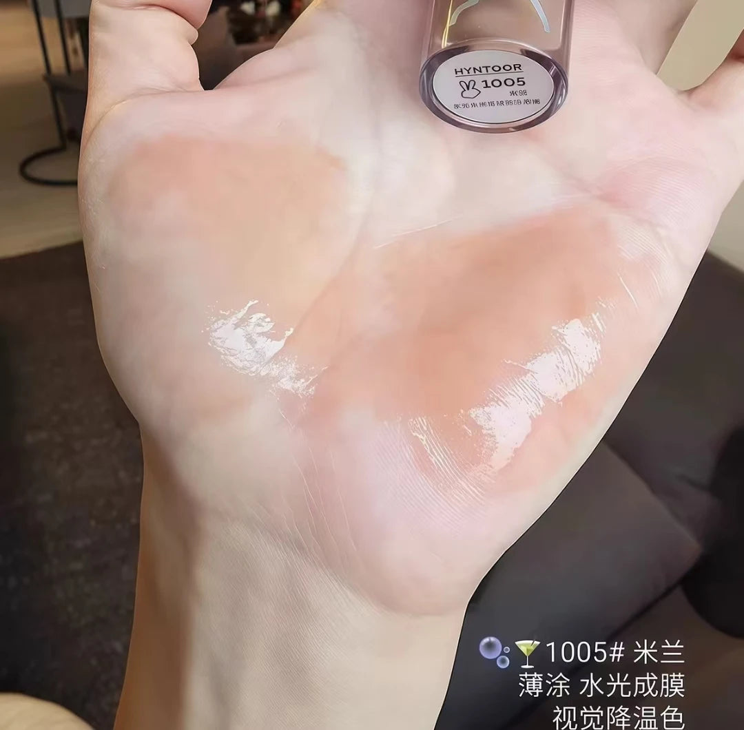 HYNTOOR Lip Gloss bottle in a romantic setting, showcasing it as a shiny lip gloss for dry lips.