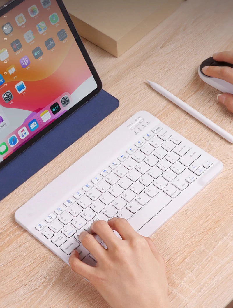 Another view of a user typing on a white Bluetooth keyboard for iPad 2024, by Orbit Gear.