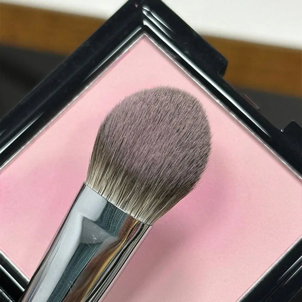 Close-up view of the Portable 17CM Peach Heart Blusher Brush, a soft tongue-shaped makeup tool.